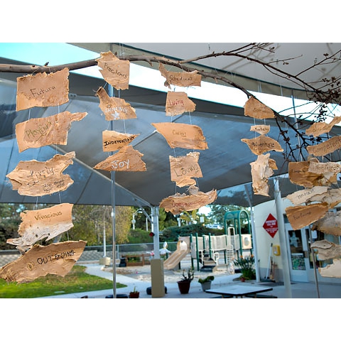 Art mobile with writing hanging from ceiling