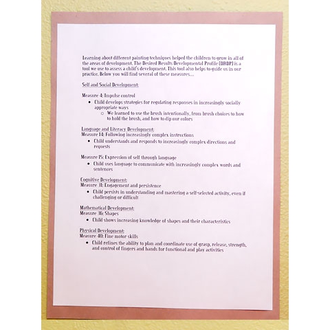Description of children’s art and its connection to DRDP displayed on wall