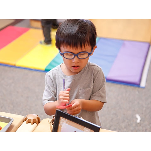 Child writing on pad