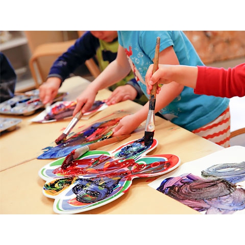 Children using paint brushes