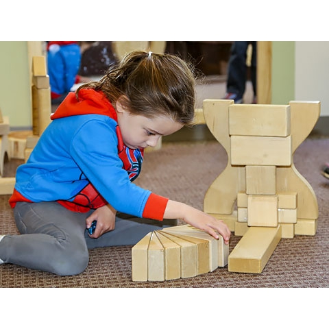 Child playing with blocks on floor