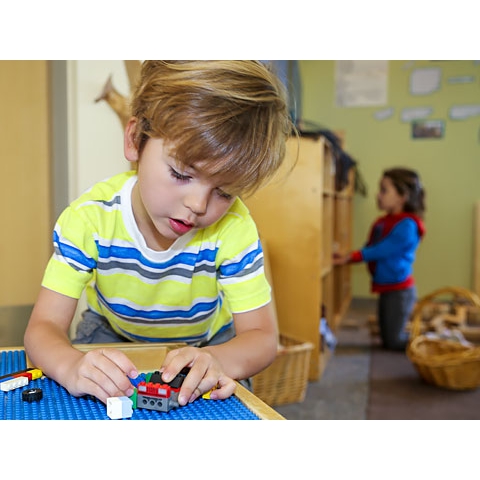 Child playing with Legos