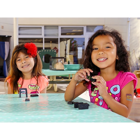 Two children playing with Dominos