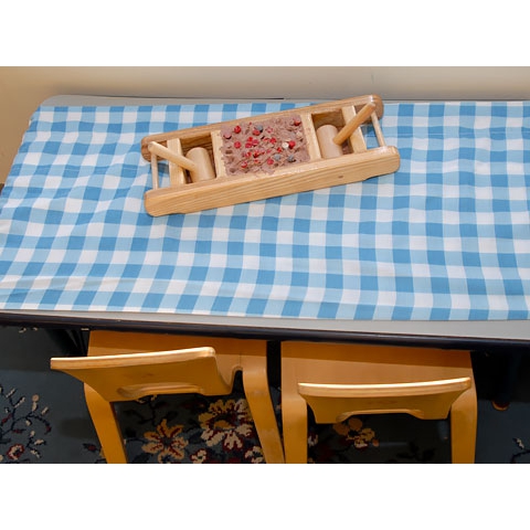 Clay on a table with wooden mallets and pegs