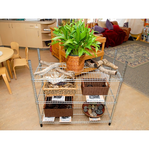 Natural materials displayed in baskets on wood shelving