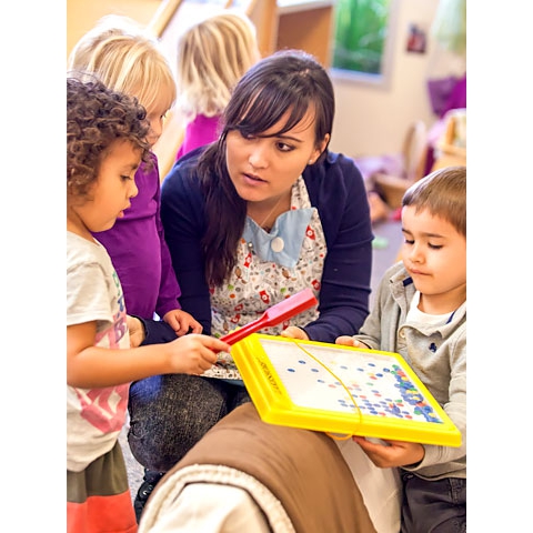 Teacher and children using magnet board