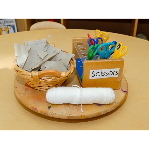 Scissors, string, and paper set on a table