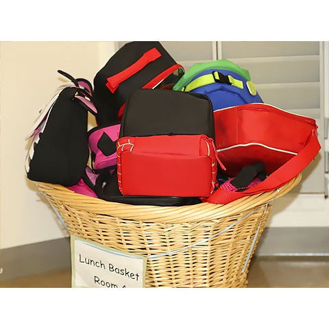 Large basket filled with children’s lunch pails