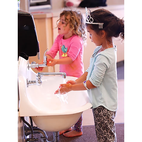 Children washing hands at sink