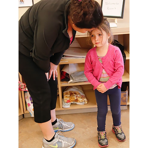 Mother speaks to child in welcome/sign-in area