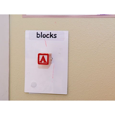 Sign that reads Blocks, with physical block and written text on wall in block area