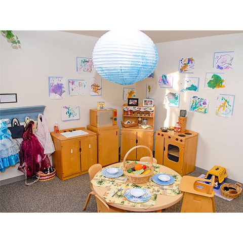 Kitchen play area with children’s art on walls
