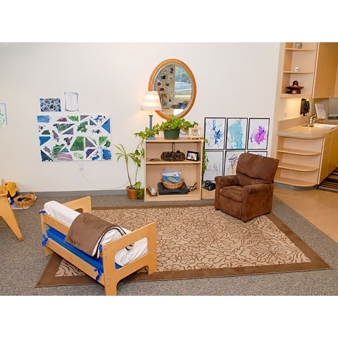 Beautiful living room area with small couch and chair, mirror and art on wall